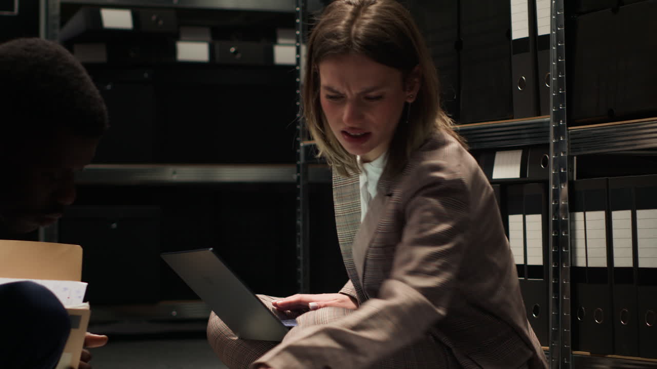 Businesswoman working with laptop in archive