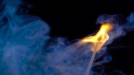 burning match on a black background in slow motion