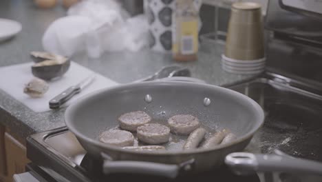 A-slowed-down-shot-of-sausage-sizzling-in-a-frying-pan