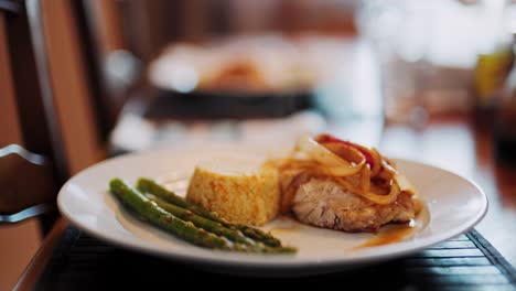 Leckere-Mahlzeit-Mit-Huhn,-Reis,-Spargel,-Zwiebeln-Auf-Dem-Teller,-Weicher-Hintergrund