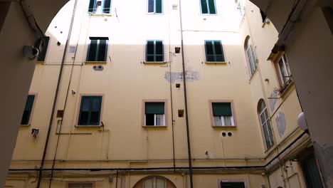 a courtyard with ornate ceiling and parked cars