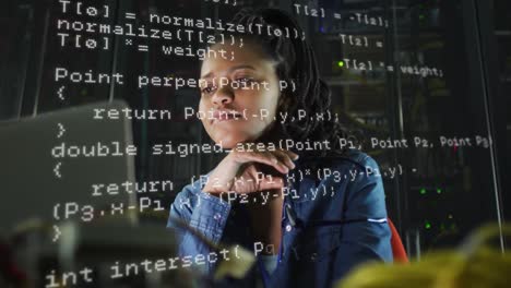 animation of data processing over biracial woman working on laptop