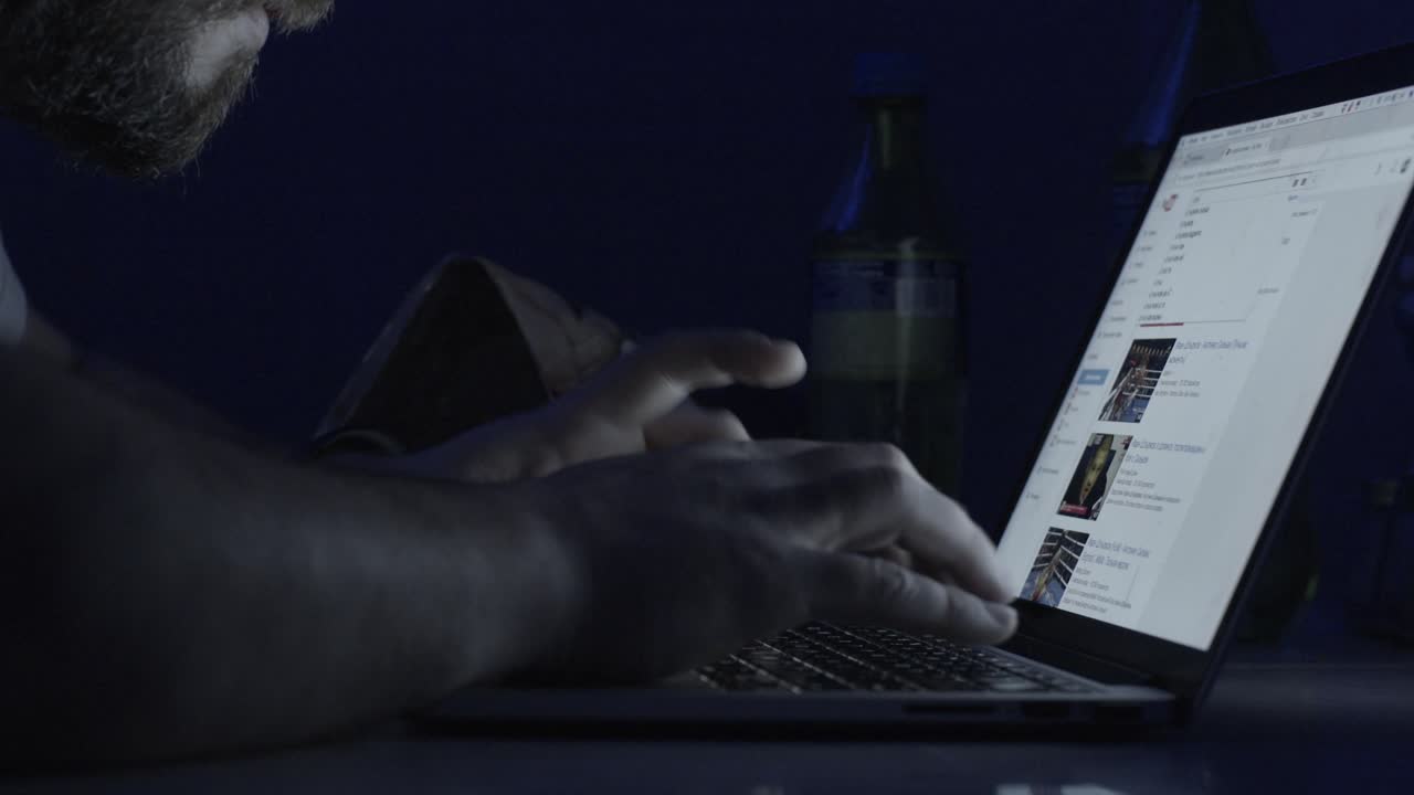 Man Working on Laptop at Night