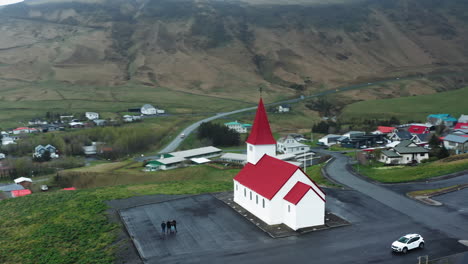 Aerial-drone-shot-of-local-Church-in-Vík-í-Mýrdal,-South-Iceland