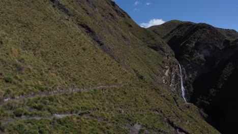 4K-drone-video:-Candela-Fasso-Waterfall-surrounded-by-rocky-formations-in-Cotopaxi,-Ecuador