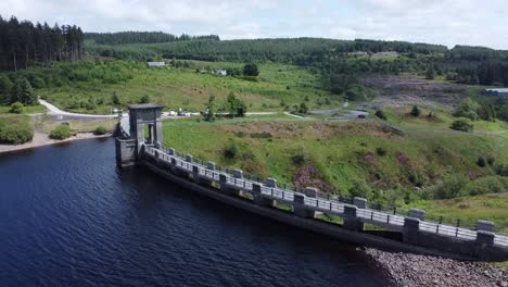 alwen reservoir welsh woodland lake water supply aerial view concrete dam countryside park rear rising shot