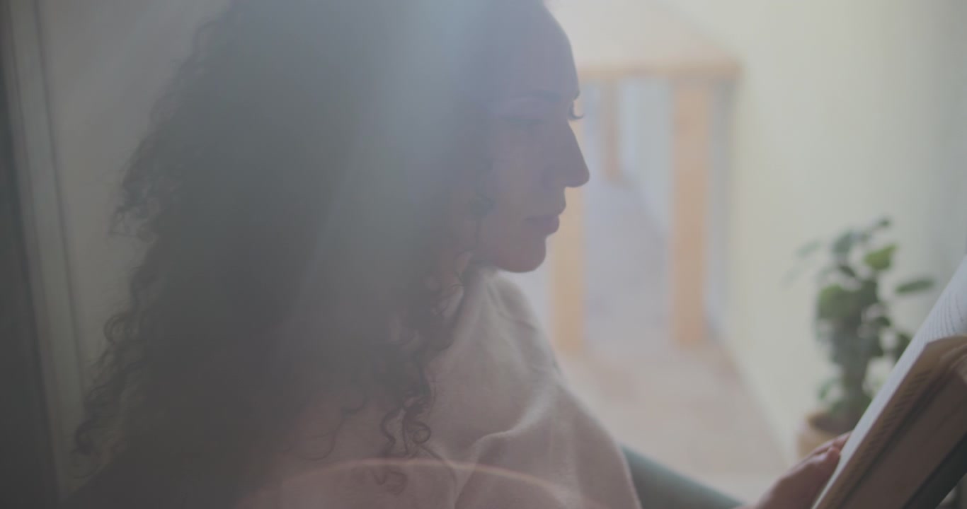 woman reading with light flaring in lens