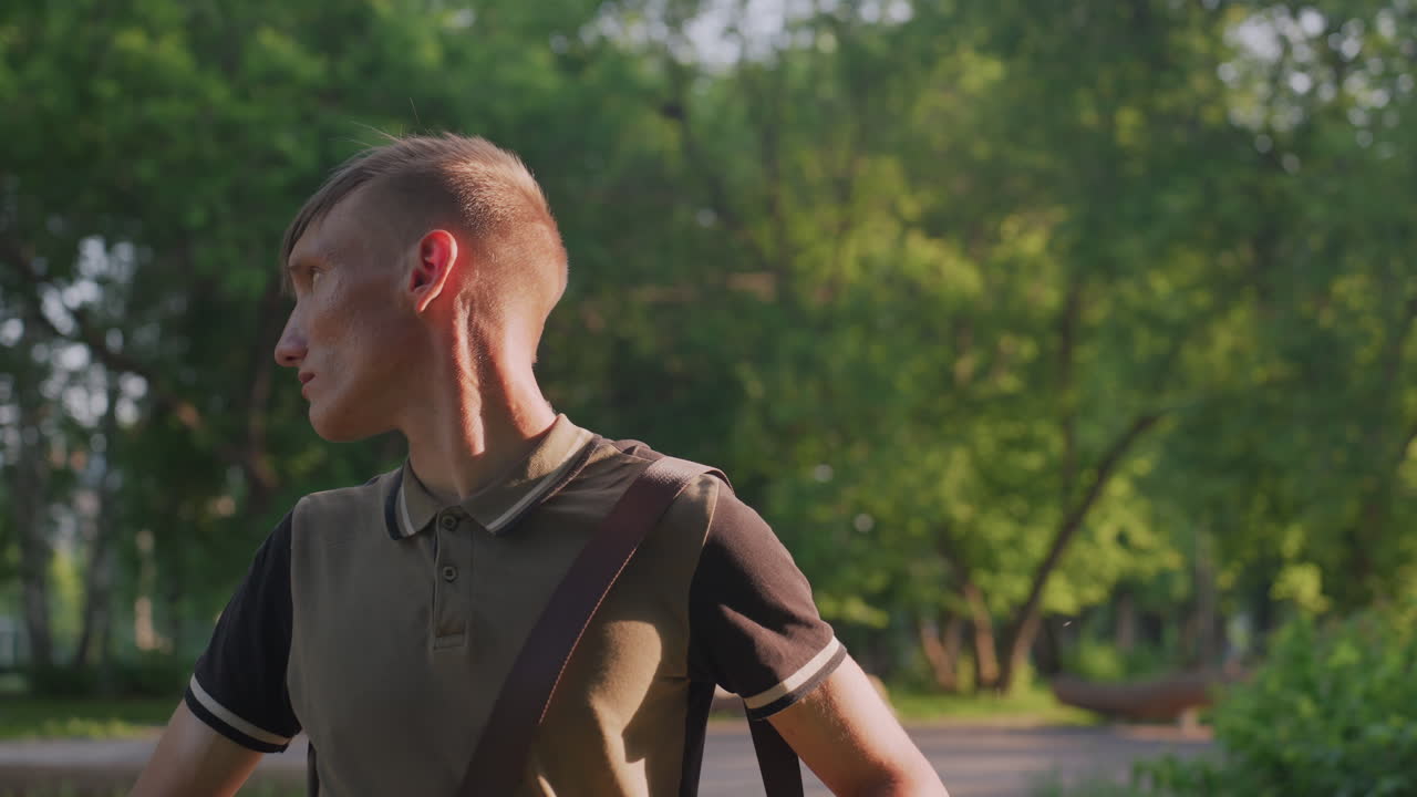 Vigilant Man Surveys Park Area Carefully, An Attentive Man Looks Around Park With Cautious Awareness, Cautious Caucasian Male Carefully Scans Park Environment While Showing Signs Of Concern