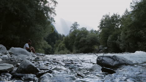 smooth traveling of a man writing on the edge of the venosc river