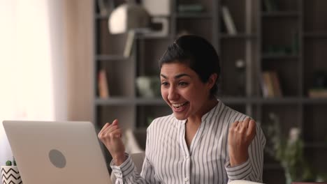 Indian employee read e-mail with good news celebrate career advance