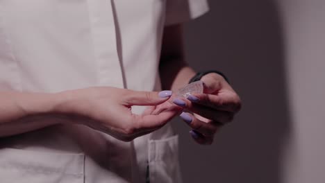 dentist holding invisalign aligners in a clinical setting