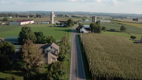 aerial reveal above road through rural american countryside