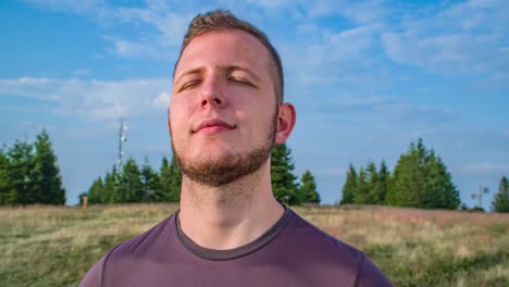 close up shot of a pensive man standing peacefully after a hike to the mountains