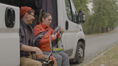 heterosexual couple sitting in a van