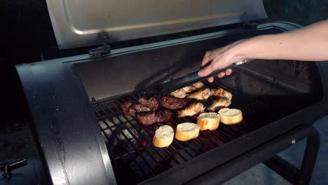 alitas de pollo y carne tierna colgando a la parrilla