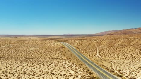 Lonely-Highway-14-or-Midland-Trail-cuts-through-the-center-of-the-Mojave-Desert's-vast-landscape