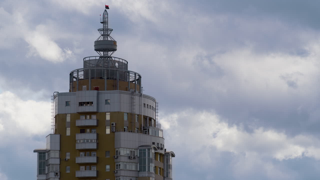 Building tower rooftop with metallic construction drone shot. Gray clouds moving
