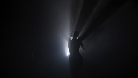 silhouette dancer in smoky studio