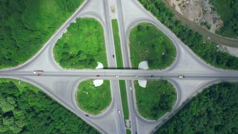 busy urban traffic. aerial top view traffic on circle road in city at day. 4k stock footage.