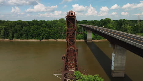 old railway bridge near twin city riverfront park in arkansas, usa - aerial drone shot