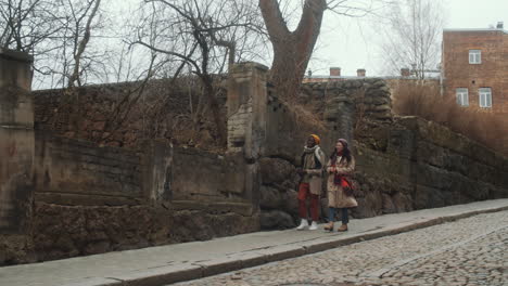 multiethnic tourist couple walking in old town