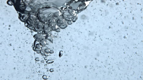 ice aqua making funnel inside glassware closeup. container with liquid tornado