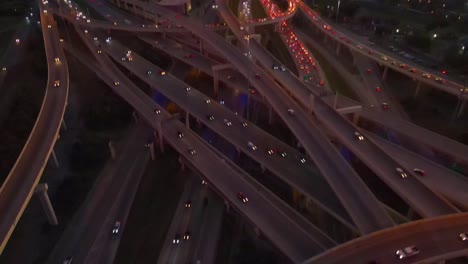 Sunset-aerial-view-looking-down-at-rush-hour-traffic-in-San-Antonio,-Texas