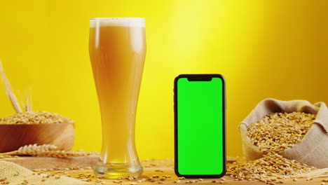 beer and mobile phone with green screen