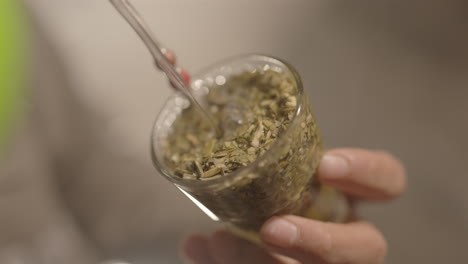 a close-up shot capturing water being poured into a mate gourd, ready for consumption.