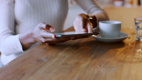 woman using tablet in a cafe