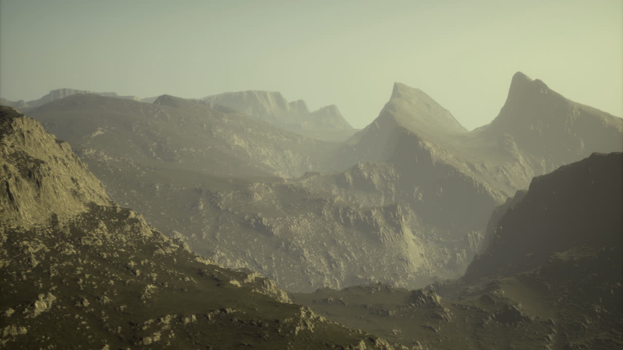 Majestic mountain range bathed in soft sunlight during early morning hours