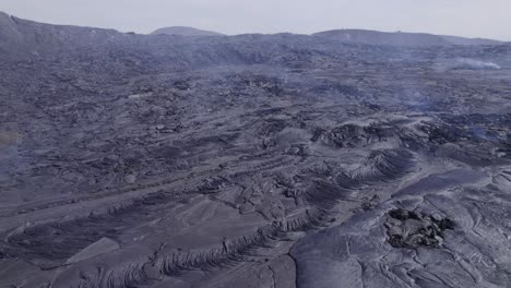 solidified lava with steam after volcanic eruption - aerial orbit