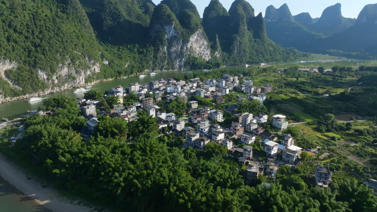 Panoramic drone shot circling the Xingping Ancient Town, summer day in China