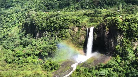 close up shot of manto de la novia waterfall with rainbow in ecuador. amazing waterfall in the course of the pastaza river near to baños de agua santa.