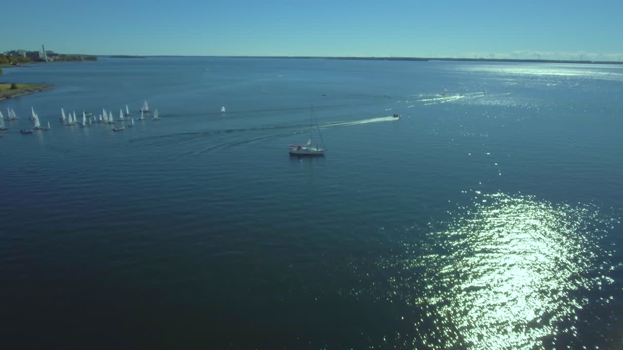 Aerial view of sea with yacht and motor boat sailing. A lot of boats sailing in the background. Ocean full of boats.