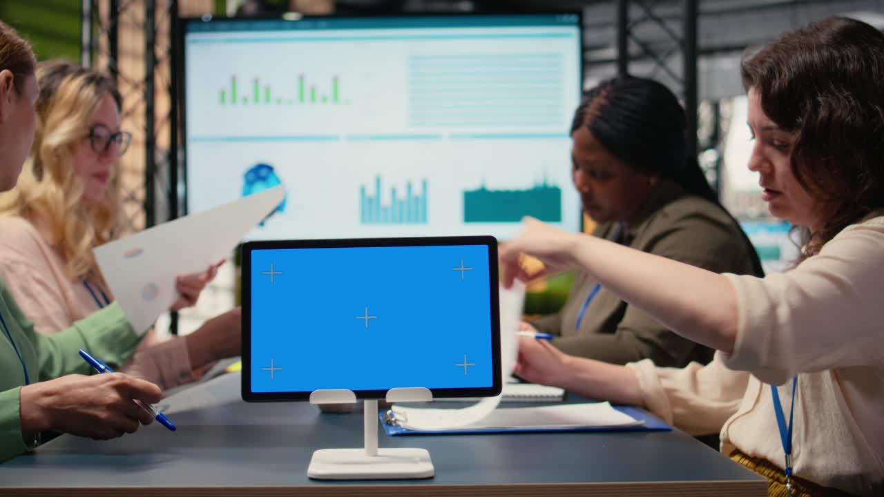 Vertical Video Multiethnic team of businesswomen with a mockup display