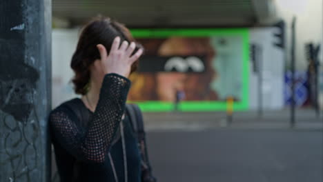 outdoor fashion portrait of young alternative style woman standing on london city street uk with busy road in background 1