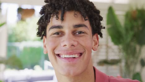 Portrait-of-happy-biracial-man-spending-time-at-home-and-looking-at-camera