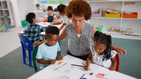 female teacher with multi-cultural elementary school pupils in art class