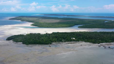 aerial-landscape-panning-right-of-Leebong-island-in-Belitung-Indonesia-at-extreme-low-tide-on-tropical-sunny-day