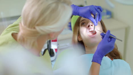 teeth treatment in dental clinic. dentist using dental tools to sick tooth