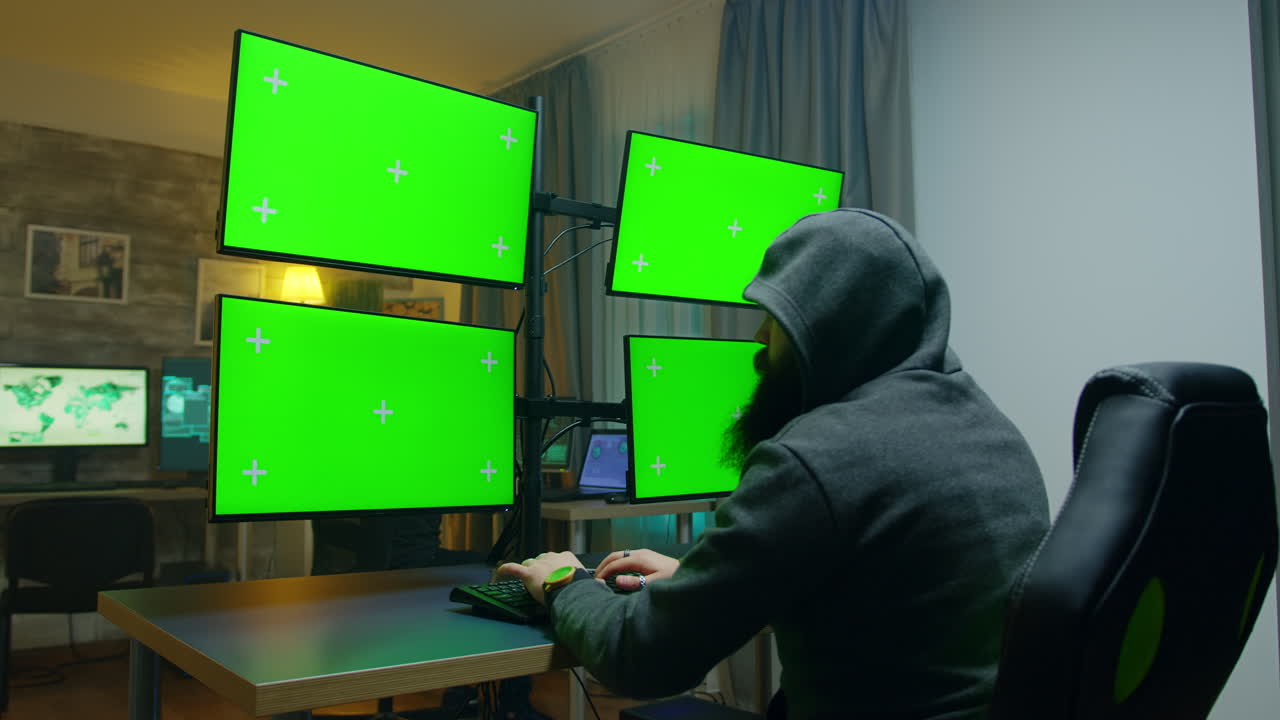 Bearded hacker hiding his face wearing a hoodie