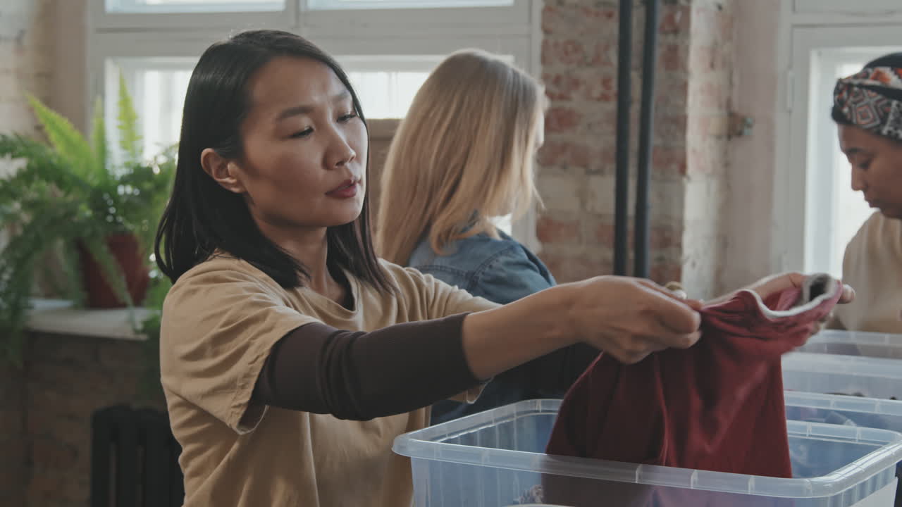 Volunteers Looking through Donated Clothes