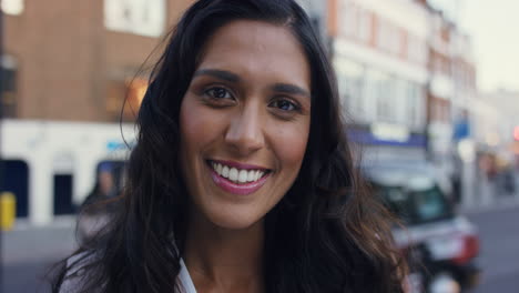 smiling portrait of beautiful woman in the city
