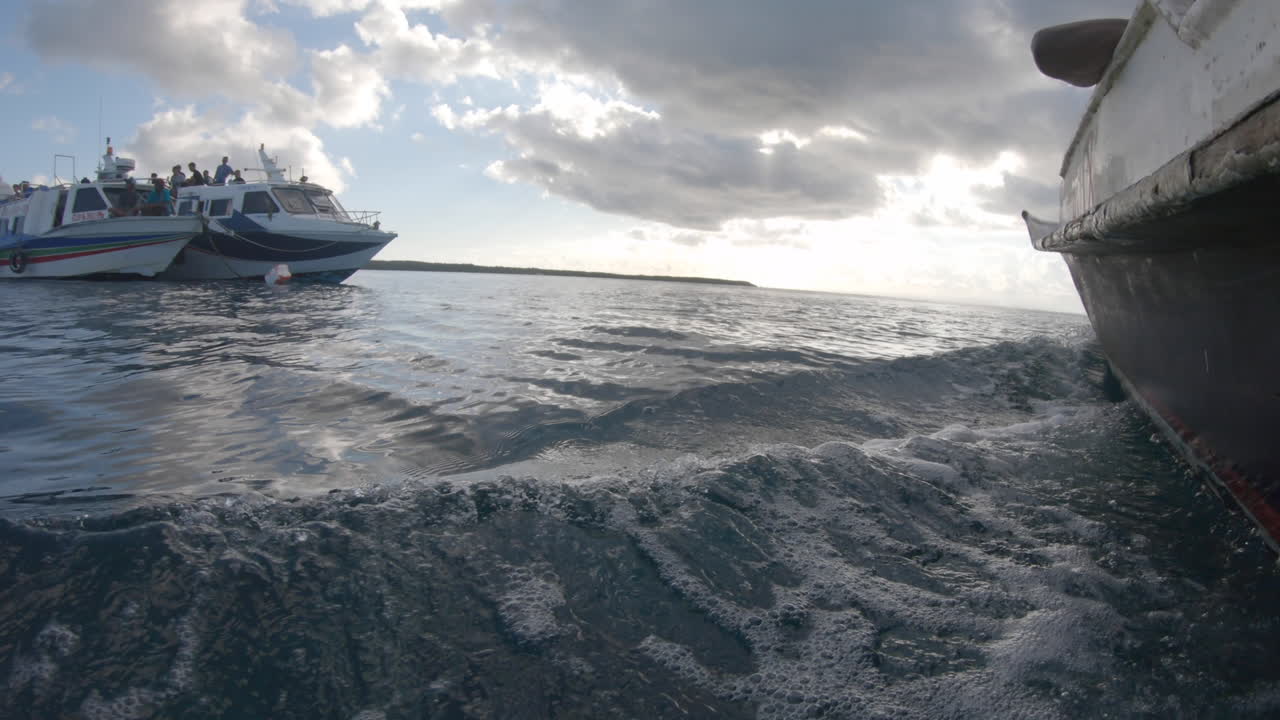 side footage of a boat moving through water in Bali Indonesia