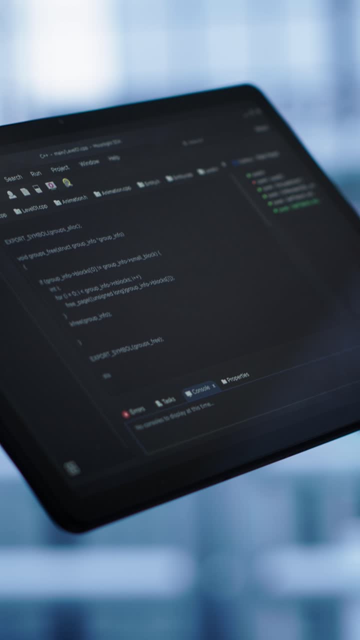 Close-up of Developer Scrolling Code on Tablet Screen
