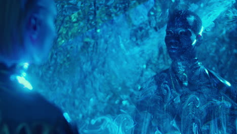 cosmic man and woman in room with laser light projection