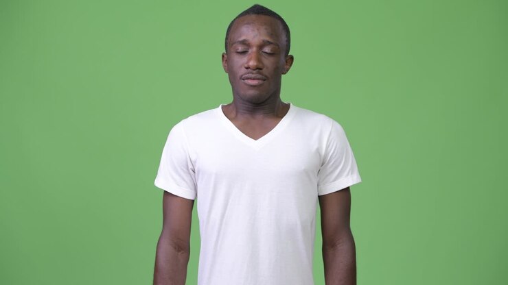 Young African man relaxing with eyes closed