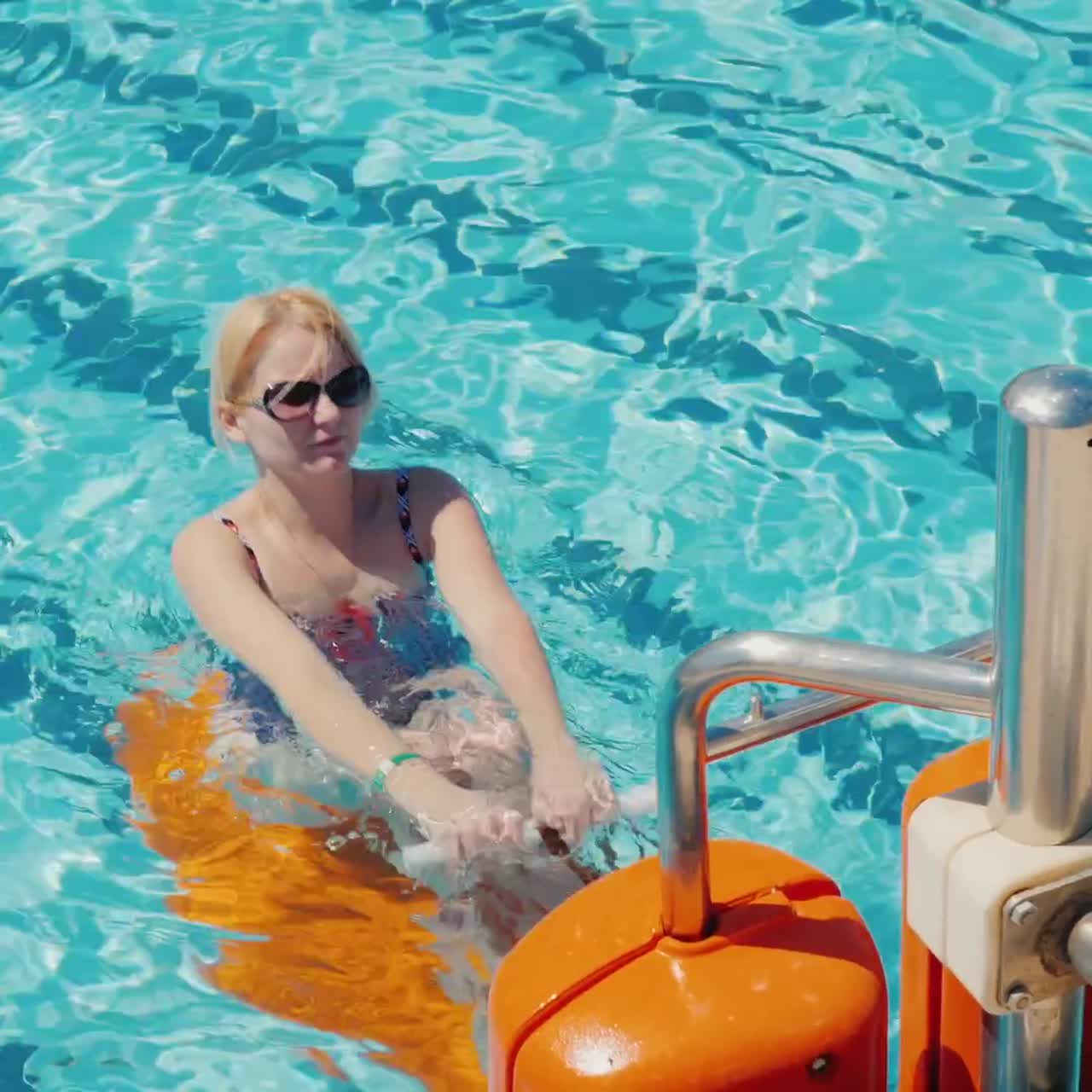 Young Woman Exercising In The Pool Outdoors In The Resort 1