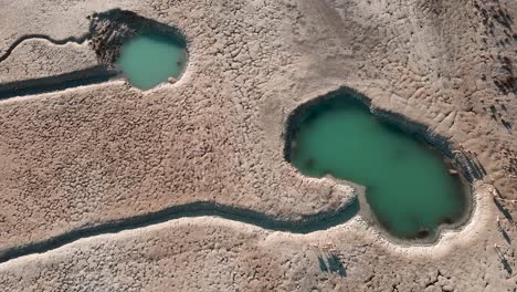 aerial clip of two water ponds in the tongariro national park with howard's mountain lodge